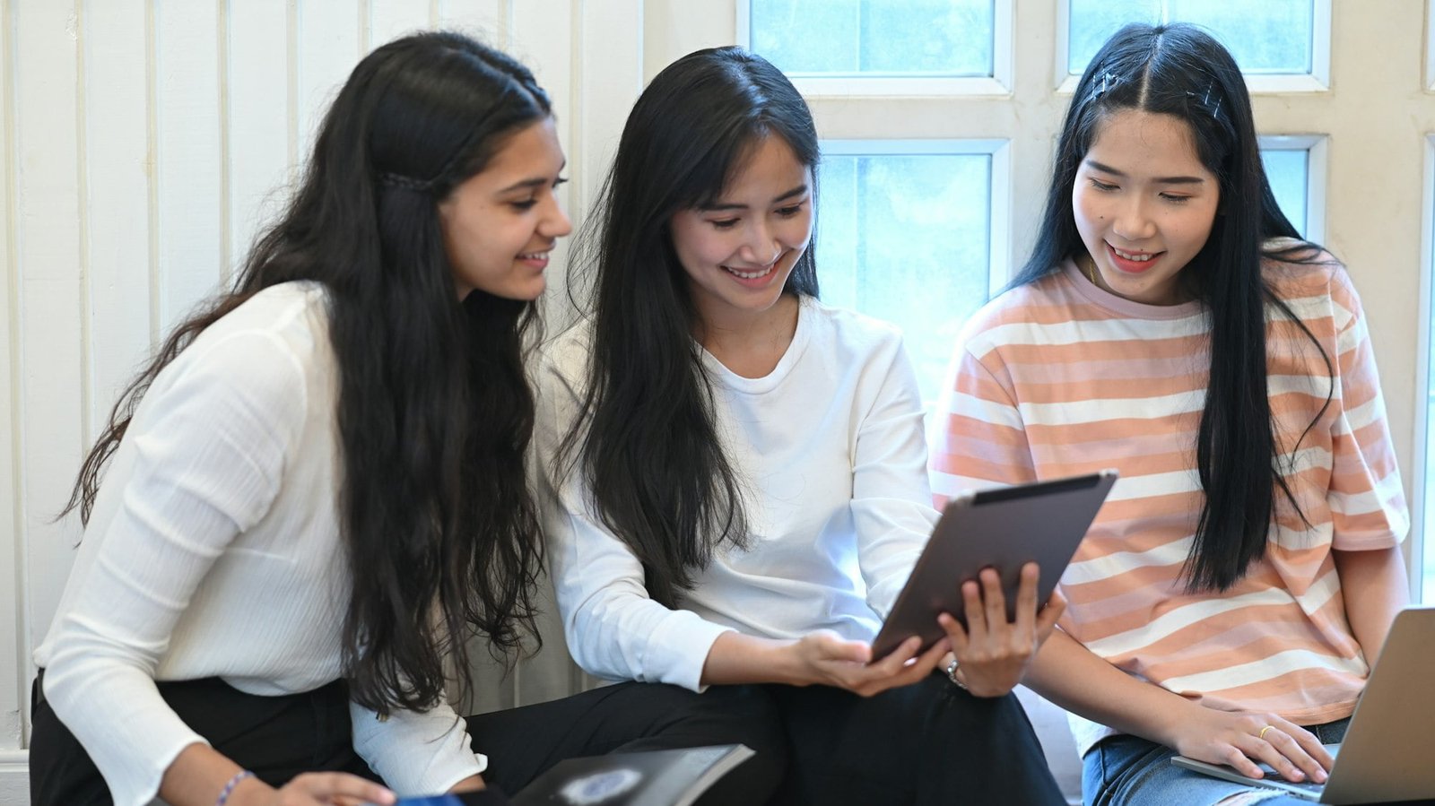 University student doing E-learning group by using a computer tablet.